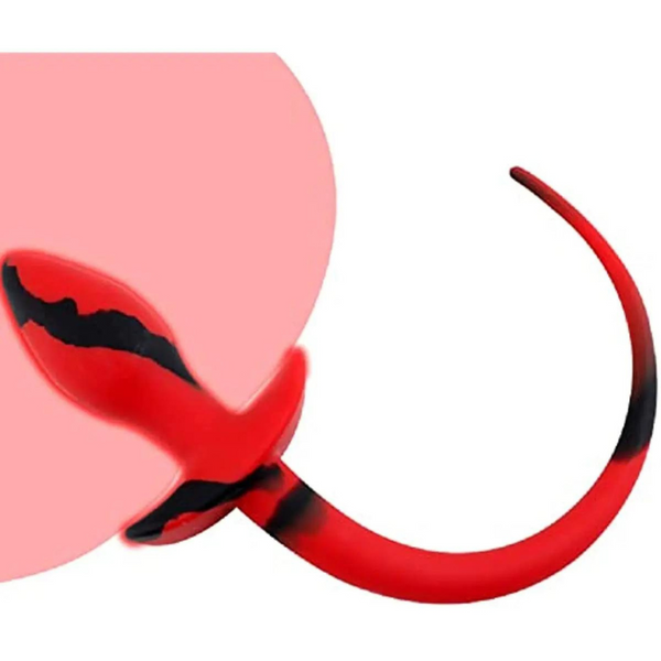 Close-up of red devil tail and pointed ear accessory against a white background