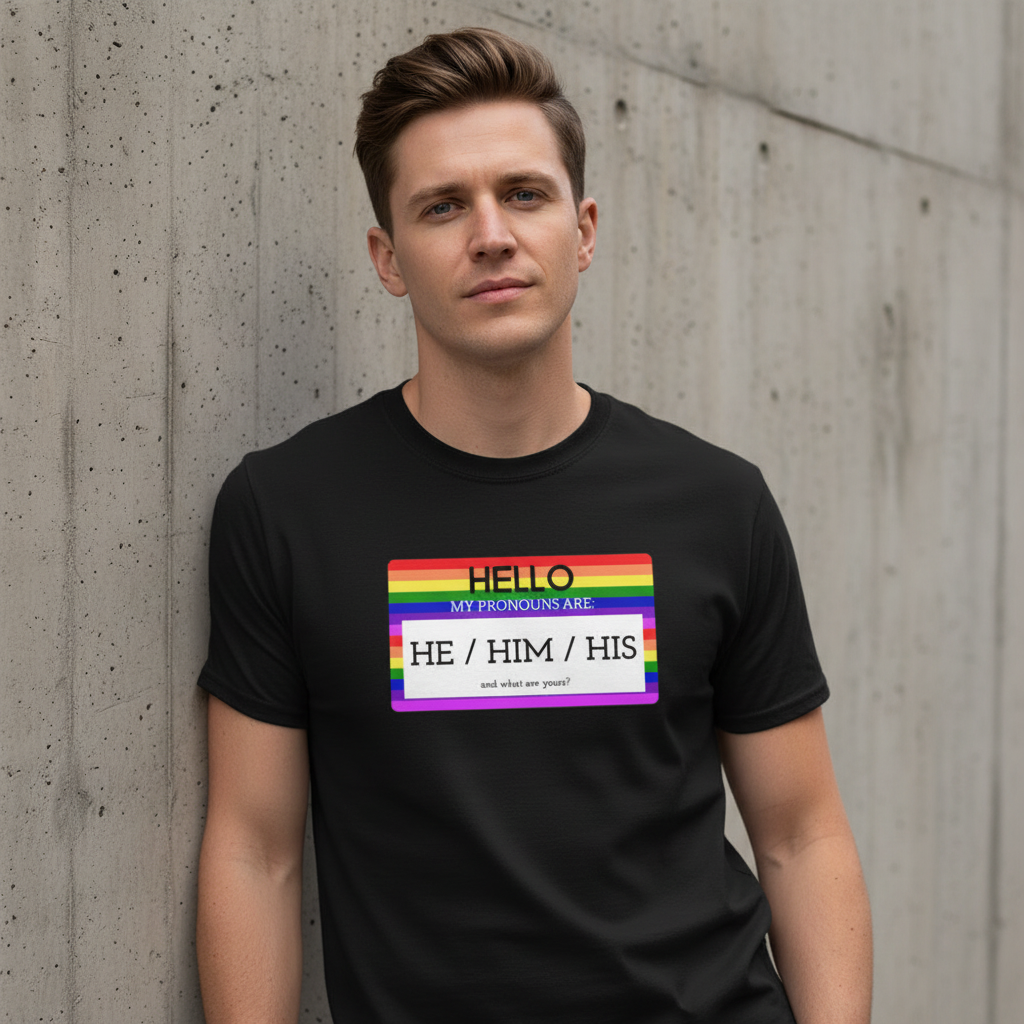 They/them/their pronouns tee with rainbow-striped "Hello My Pronouns Are He / Him / His" label