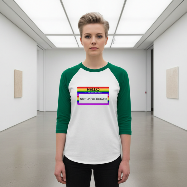 3/4 sleeve raglan shirt reads “HELLO my pronouns are NOT UP FOR DEBATE”; person with short blond hair, rainbow name tag
