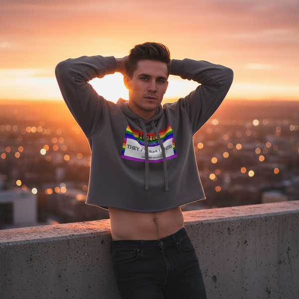 Hello My Pronouns Are They / Them / Theirs crop hoodie with rainbow Pride graphic, worn rooftop at sunset