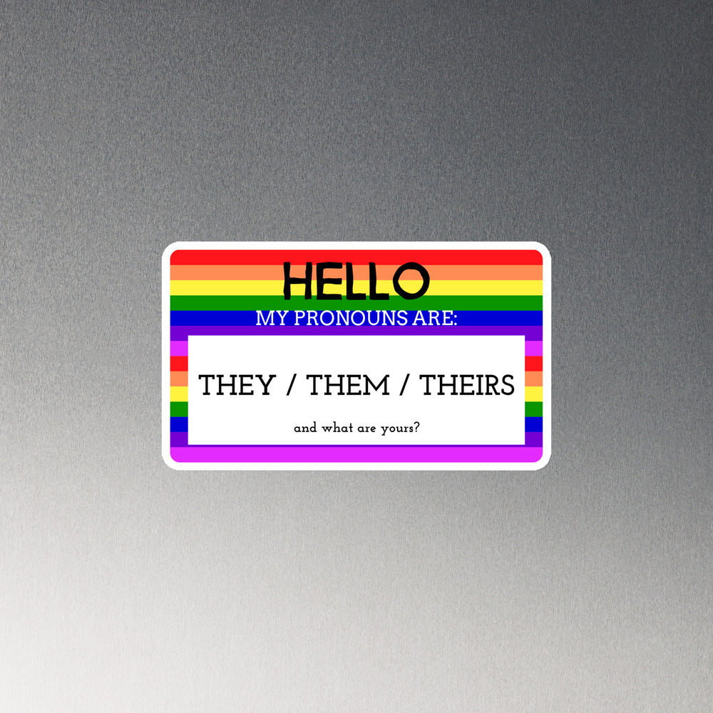Rainbow-striped rectangular magnet reading “Hello, my pronouns are: they / them / theirs”