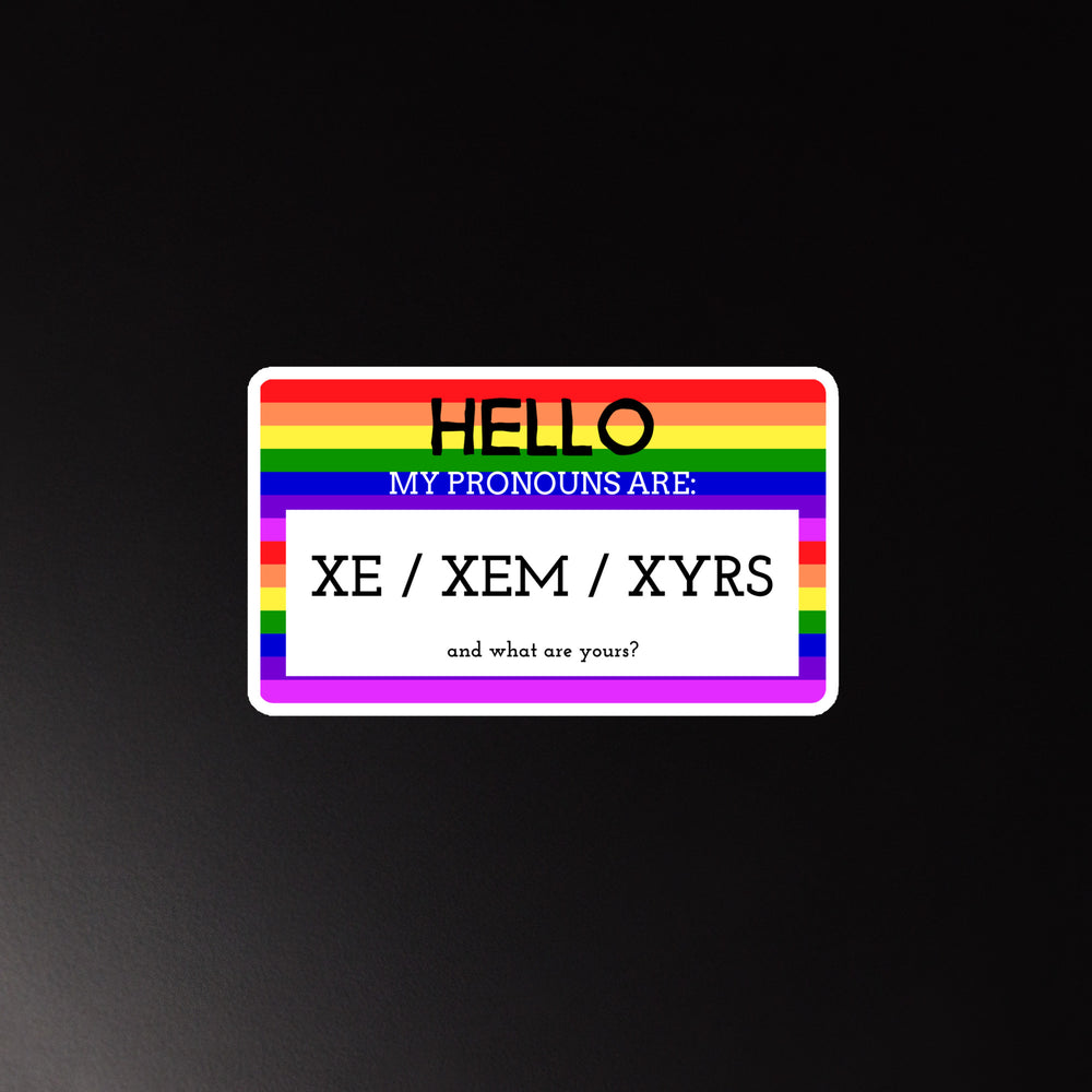 Magnet with a rainbow border on black, showing “HELLO MY PRONOUNS ARE: XE / XEM / XYRS”—a bold nod to queer pride.