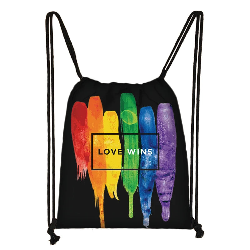 Black drawstring bag with rainbow brushstrokes and “LOVE WINS” text