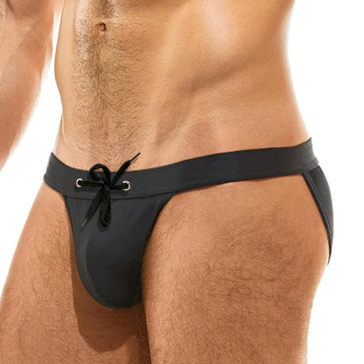 Cropped model wearing black high-cut bikini briefs with a front tie