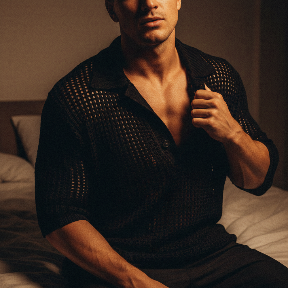 Cropped person wearing a black open-knit collared sweater shirt on a bed