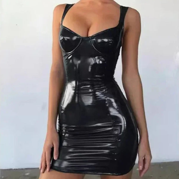 Man in shiny black Hot Dom Fantasy Latex Outfit Set with thin straps stands in minimalist room; white walls, dark floors, geometric lines.