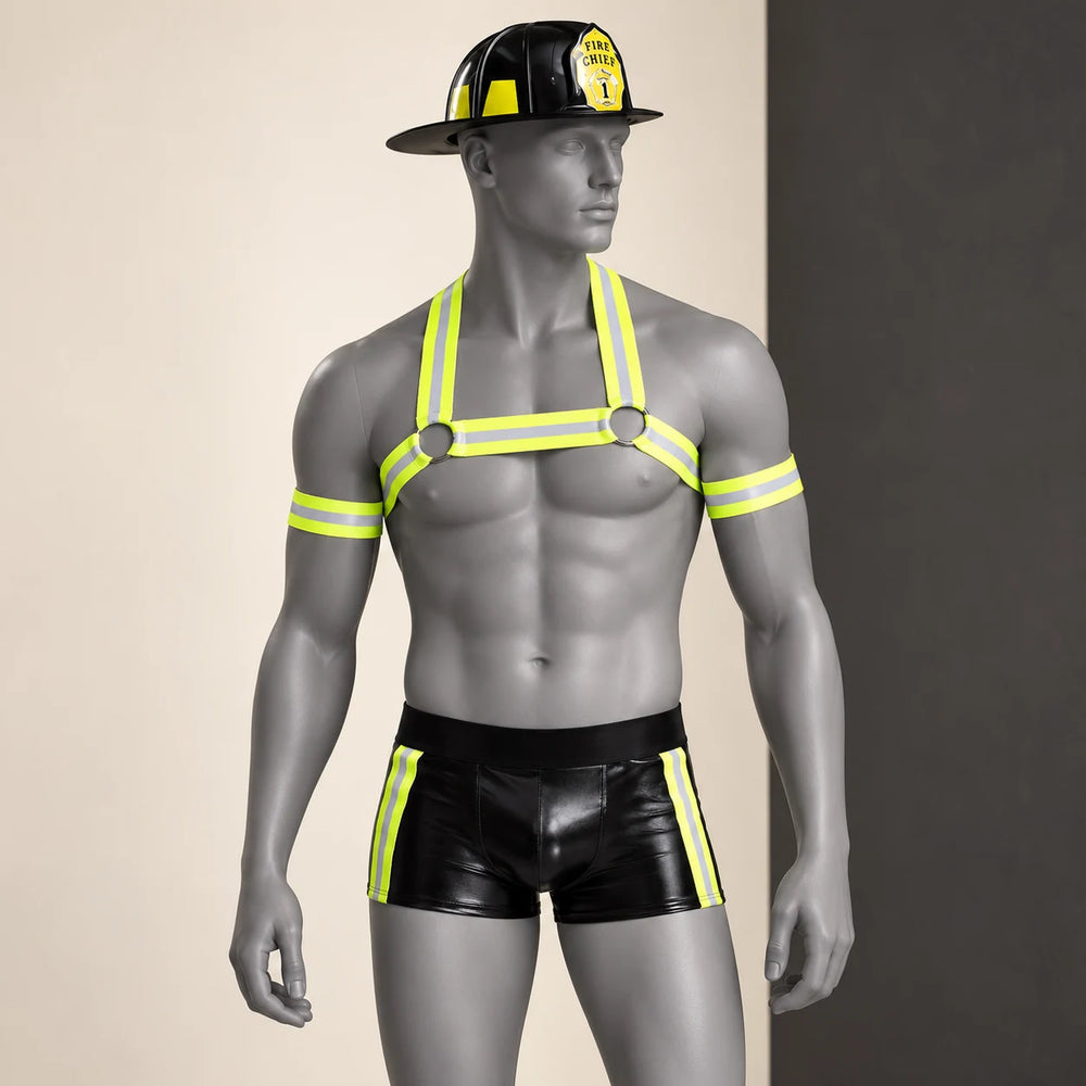Front three-quarter view of the Kinky Fireman costume on a grey mannequin, with helmet, neon-yellow harness and trimmed black trunks.