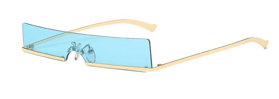 Side view of rimless sunglasses with a wide blue shield lens and gold arms