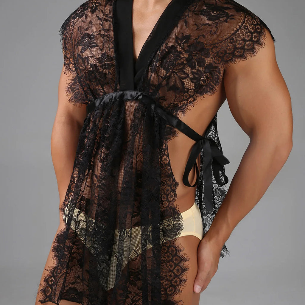 Close-up model wearing a black floral lace robe with satin ties over cream briefs