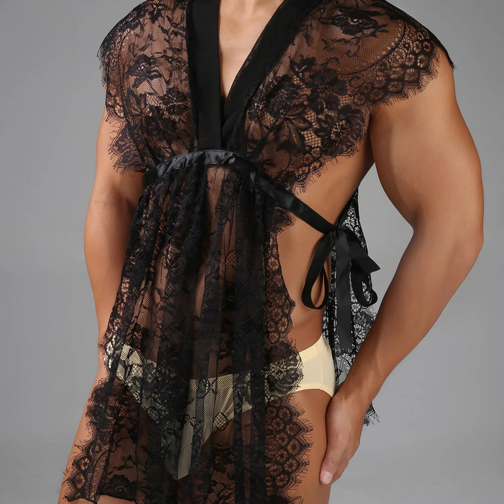 Close-up model wearing a black floral lace robe with satin ties over cream briefs