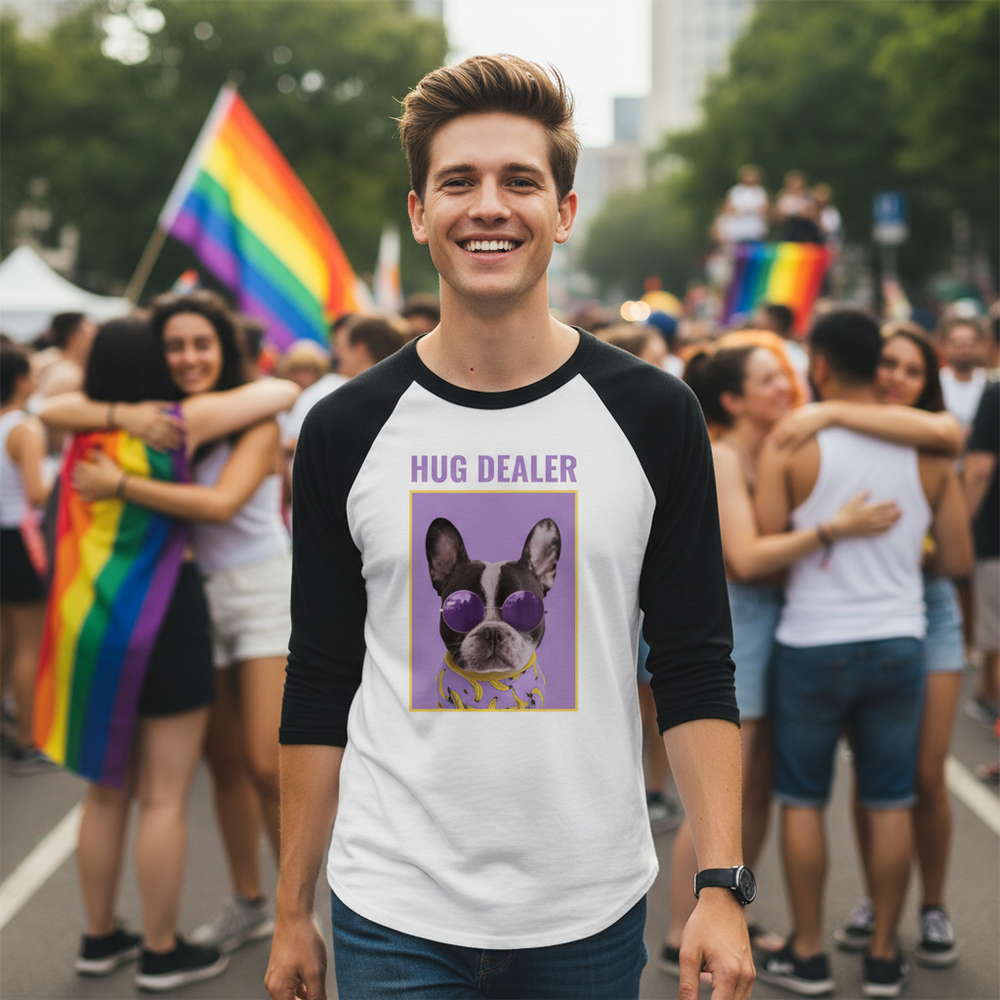 3/4 sleeve raglan shirt with “Hug Dealer” text, worn by a smiling guy at Pride