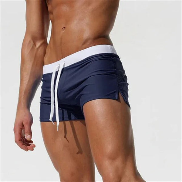 Side view of navy blue men's swim shorts with a white waistband and drawstring