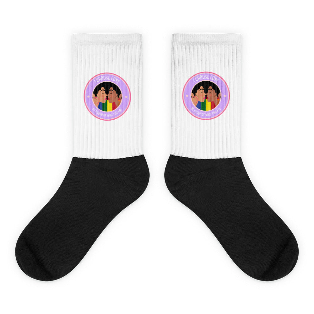 Pair of black-and-white crew socks with rainbow kissing-faces badges and “I CHOOSE LOVE” text