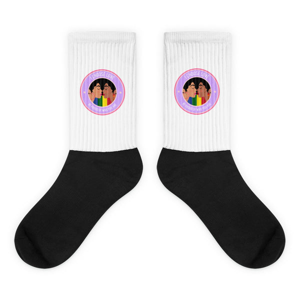 Pair of black-and-white crew socks with rainbow kissing-faces badges and “I CHOOSE LOVE” text
