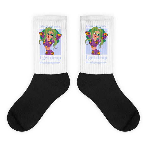 Pair of white-and-black socks with a green-haired cartoon woman and “I get drop dead gorgeous” text