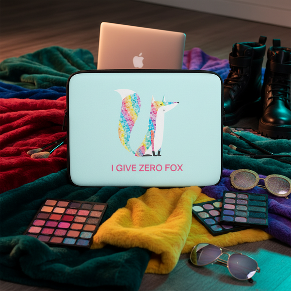Glitter laptop sleeve with “I Give Zero Fox” in bold, rainbow fox art, on a plush blanket with boots, sunnies, palettes