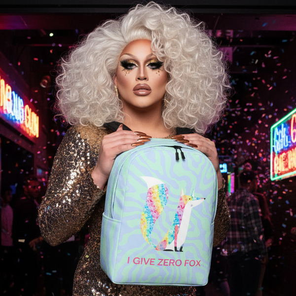 I Give Zero Fox Glitter Minimalist Backpack with colorful fox, held by a drag queen in a gold dress