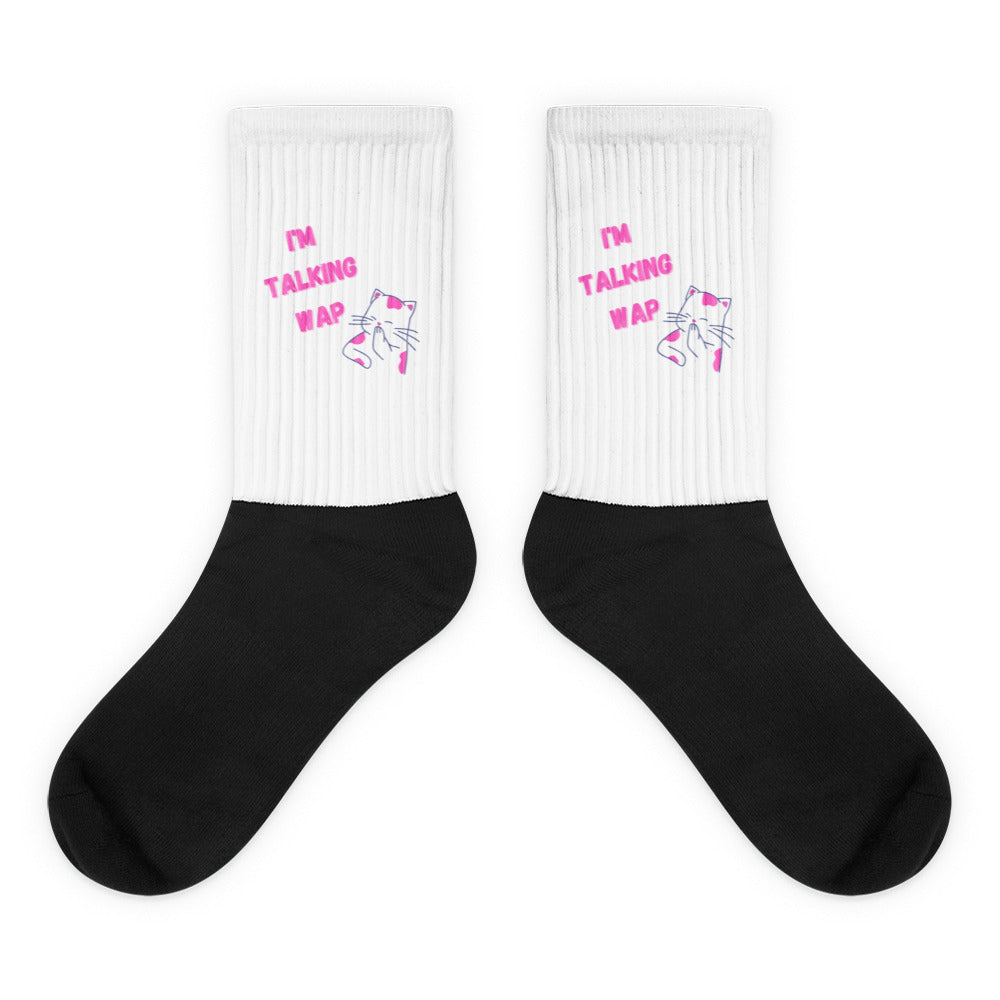 Pair of white ribbed socks with black feet, pink “I'M TALKING WAP” text, and cat graphics