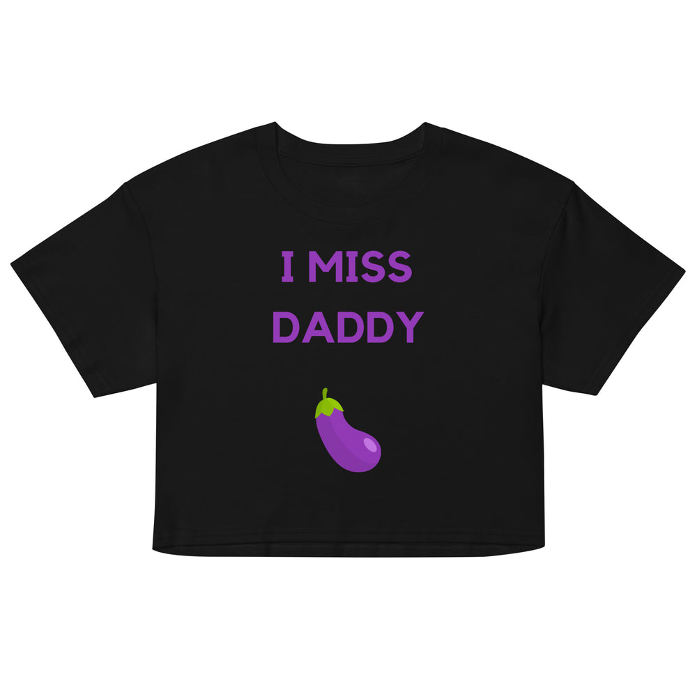 Front view of a black crop top reading “I MISS DADDY” above a purple eggplant graphic