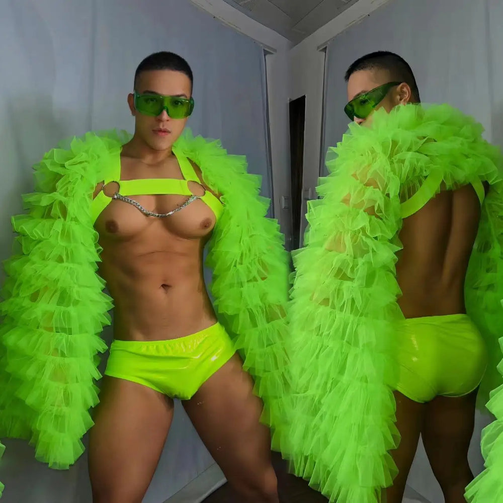 Two views of a model wearing a neon green ruffled tulle coat, chain harness, and briefs