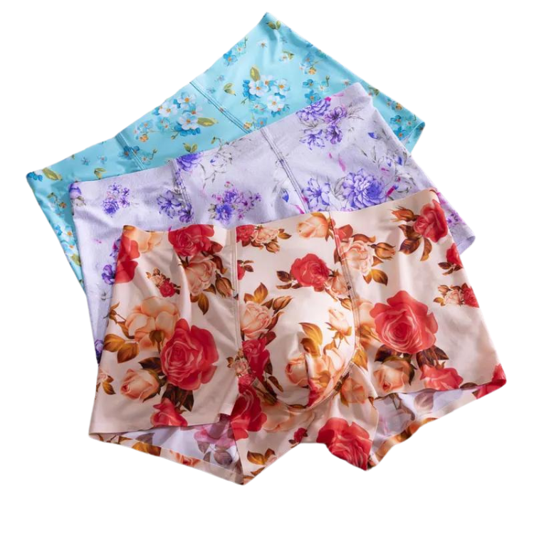 Three overlapping pairs of floral-print boxer briefs in blue, lavender, and rose patterns