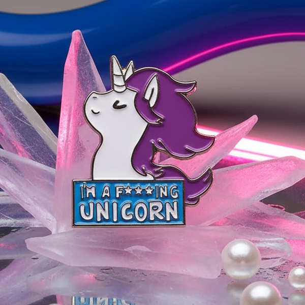 Enamel pin showing a white and purple unicorn above “I’m a F***ing Unicorn” text