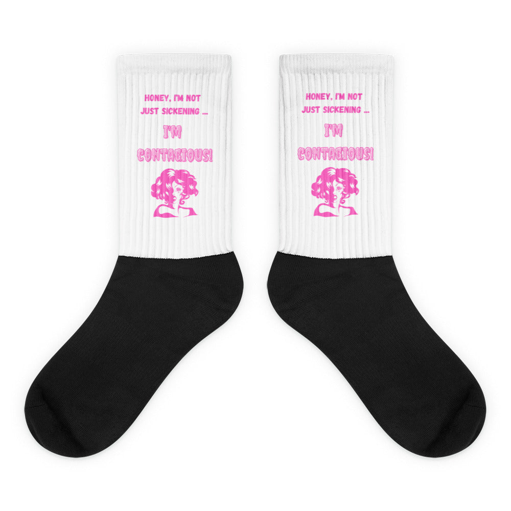 Pair of black-and-white socks with pink “I’m Contagious!” artwork and text