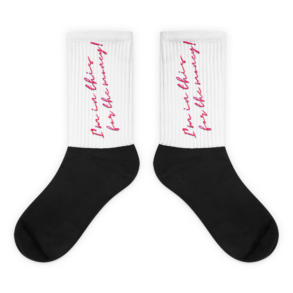 Pair of black socks with white ribbed cuffs reading “I’m in this for the money” in pink script