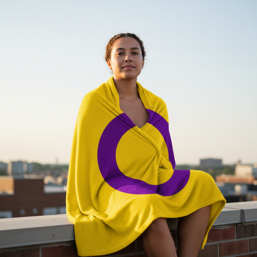 Intersex Flag Throw Blanket with bold yellow and purple circle wraps a person on a rooftop at sunset