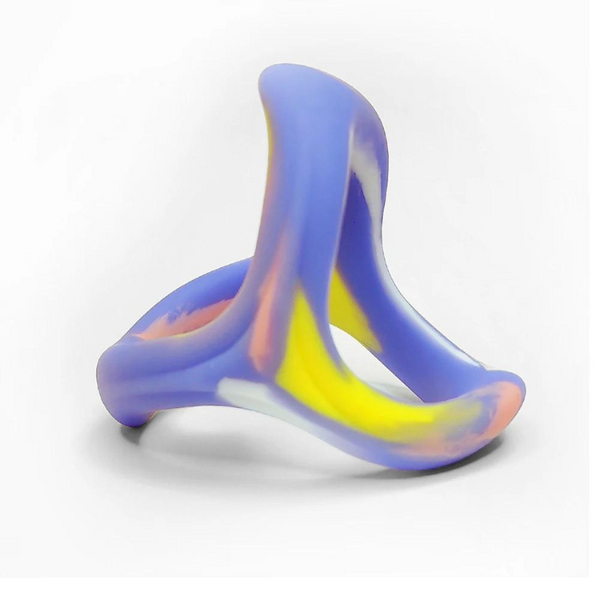 Three-loop purple, yellow, and translucent silicone cock ring standing upright on white