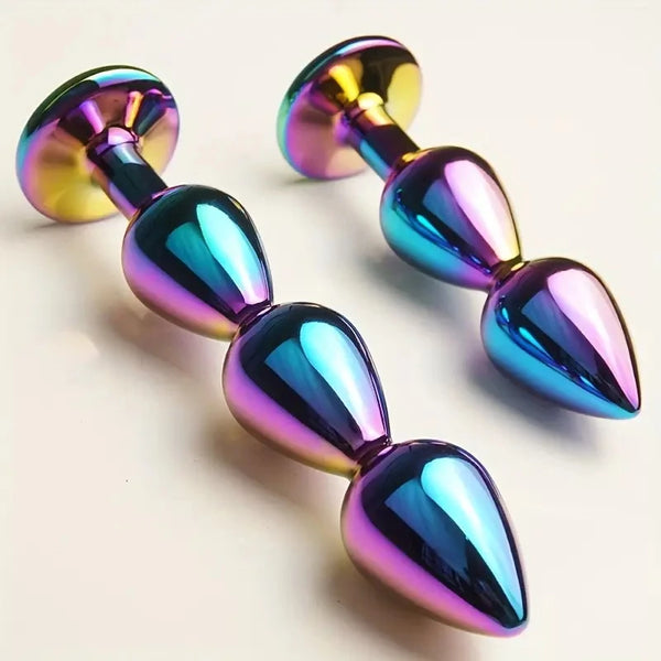 Two iridescent metallic anal plugs with double teardrop bulbs and wide bases