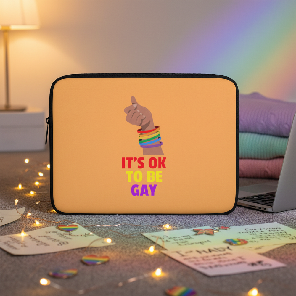 Neoprene laptop sleeve with “ITS OK TO BE GAY” in rainbow colors, raised fist with rainbow bracelets