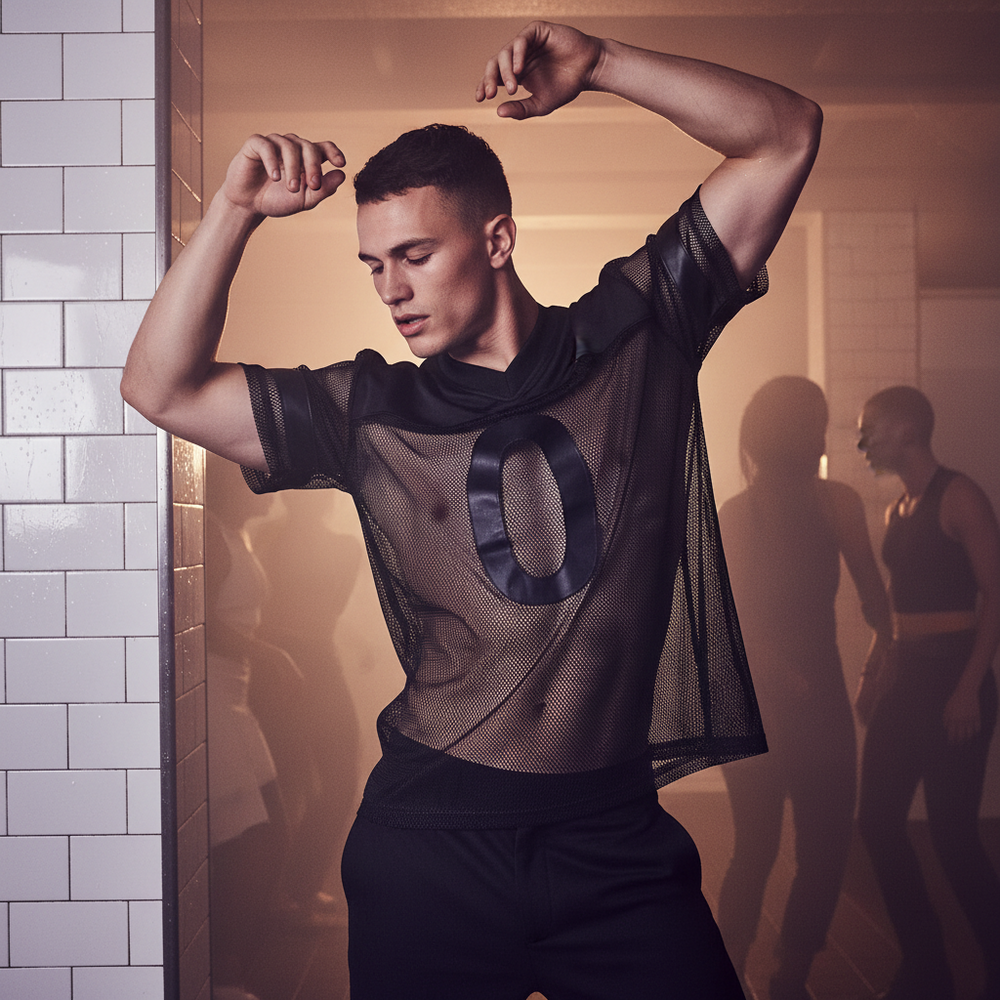 Model posing in a black mesh jersey with a large glossy zero on the front