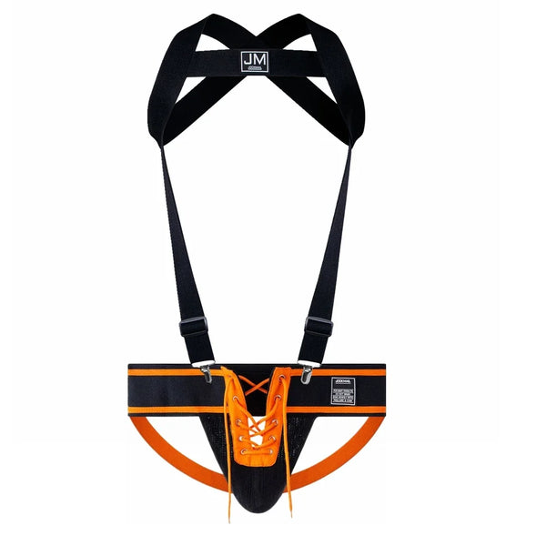 Front-facing black and orange jockstrap with detachable black chest harness and orange lacing