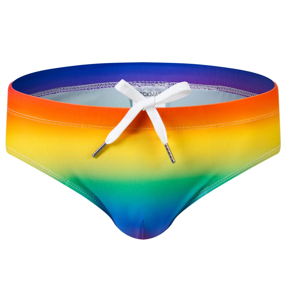 Front view of rainbow-gradient swim briefs with a white drawstring and contoured pouch