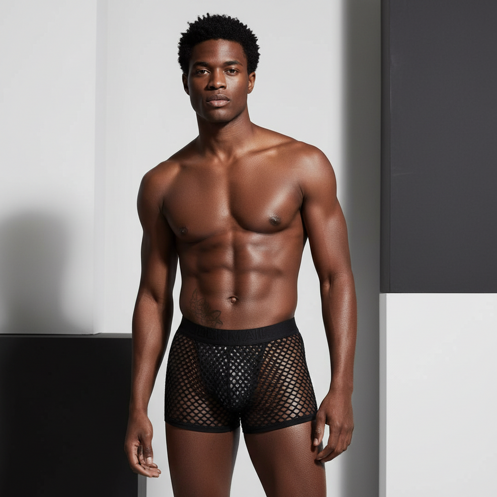 Front-facing model wearing black fishnet underwear shorts with a solid pouch