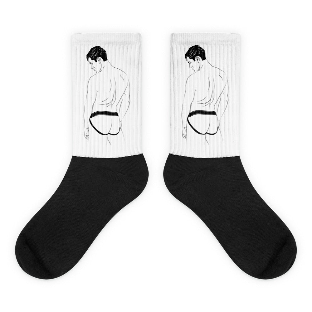 Pair of black-and-white crew socks with a shirtless man in a jockstrap illustration