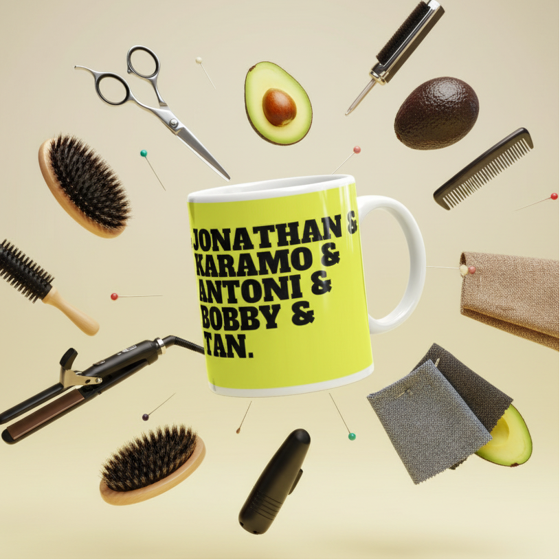 Lime-green mug reading “JONATHAN & KARAMO & ANTONI & BOBBY & TAN.” amid styling tools and avocados