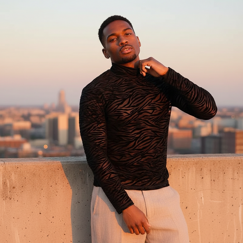 Model wearing a sheer black zebra-pattern turtleneck shirt on a rooftop