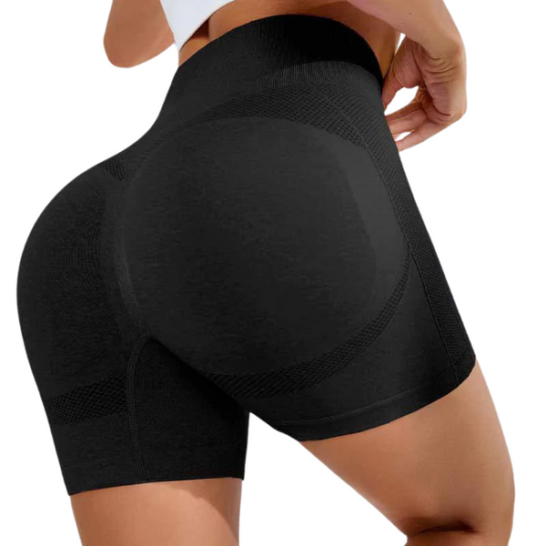 Rear close-up of a person wearing black high-waisted, shaping shorts with mesh panels
