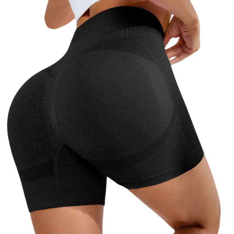 Rear close-up of a person wearing black high-waisted, shaping shorts with mesh panels