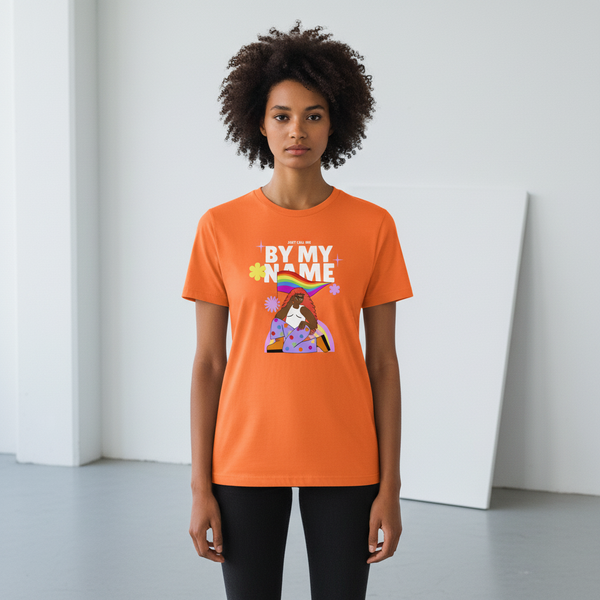 Orange “Just Call Me By My Name” tee with a rainbow Pride flag, florals, and sparkles