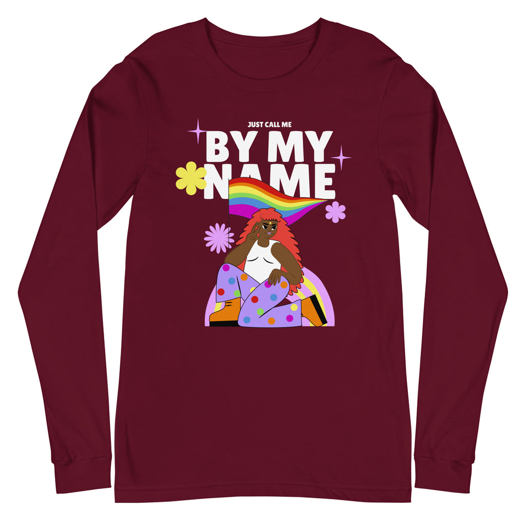 Front view of a burgundy long-sleeve shirt reading “JUST CALL ME BY MY NAME,” with a rainbow and illustrated figure