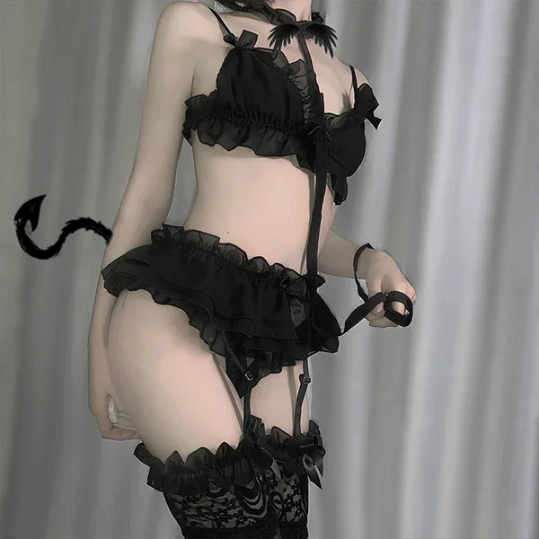 Cropped model in black ruffled lingerie with garter straps, thigh-high stockings, and a devil tail
