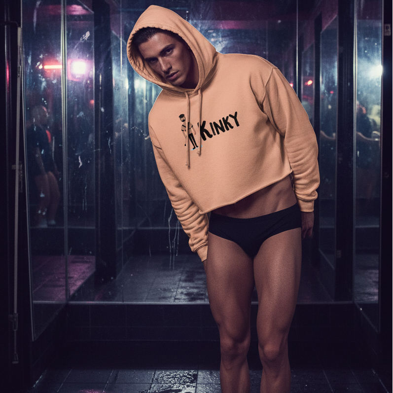 Model wearing a tan cropped hoodie with a hood and “KINKY” chest graphic