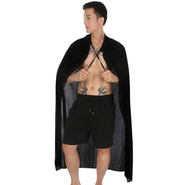 Front-view model wearing a long black sheer cape over black shorts, holding it open