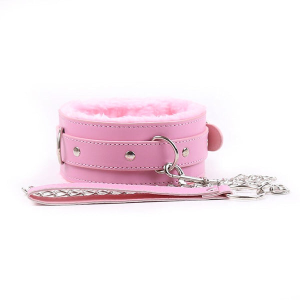 Pink fur-lined bondage collar with metal rings, studs, and a matching leash on white