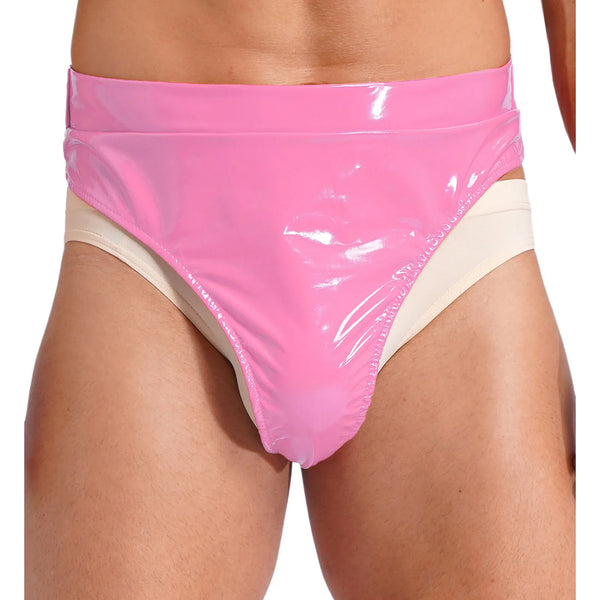 Front close-up of a model wearing glossy pink fetish briefs over beige briefs