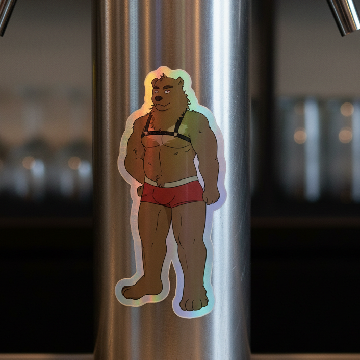 Gay Bear Holographic Sticker shows a cartoon bear rocking a black bra and red shorts, strutting on metal with glassware behind.