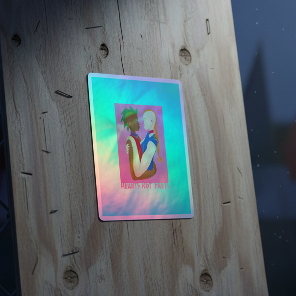 Hearts Not Parts holographic sticker: rainbow vinyl, two folks—one dark-skinned with green hair, one pale and bald—hugging. Below: "HEARTS NOT PARTS.